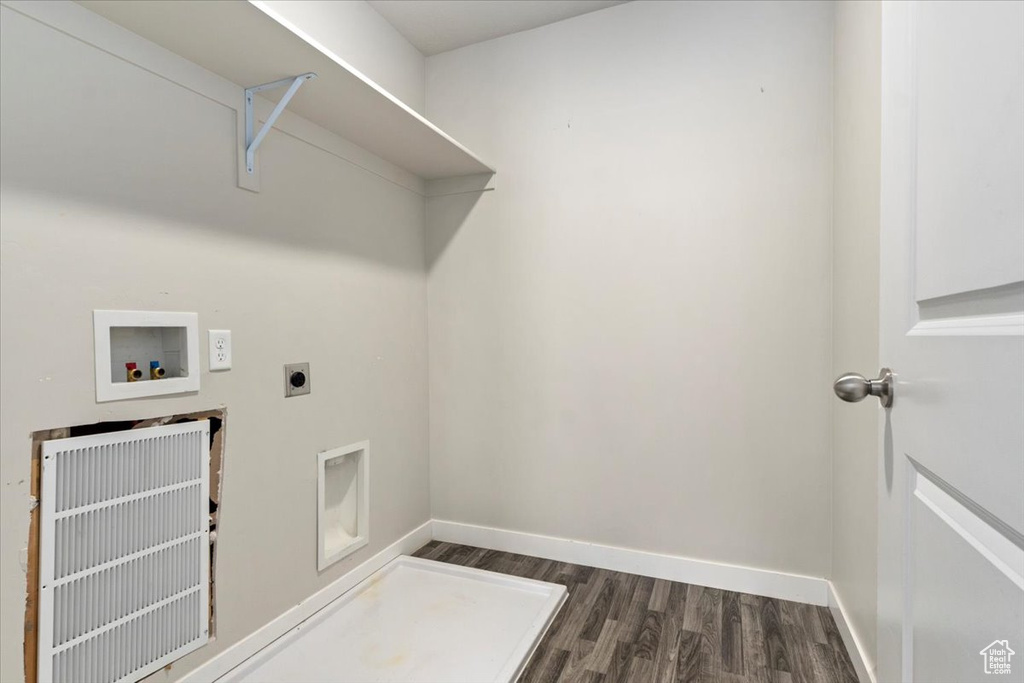 Laundry area with washer hookup, hookup for an electric dryer, dark wood-style floors, and baseboards