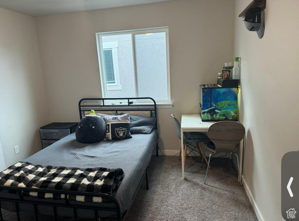 Carpeted bedroom with baseboards