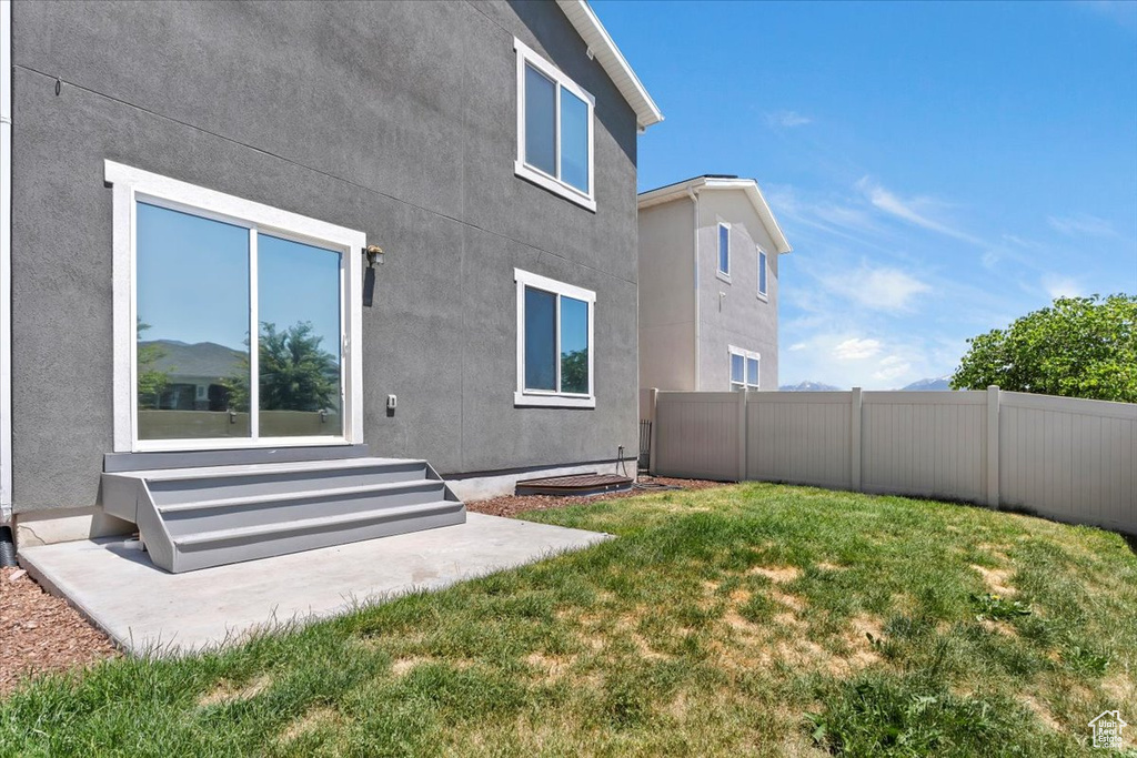 Back of house featuring entry steps and stucco siding