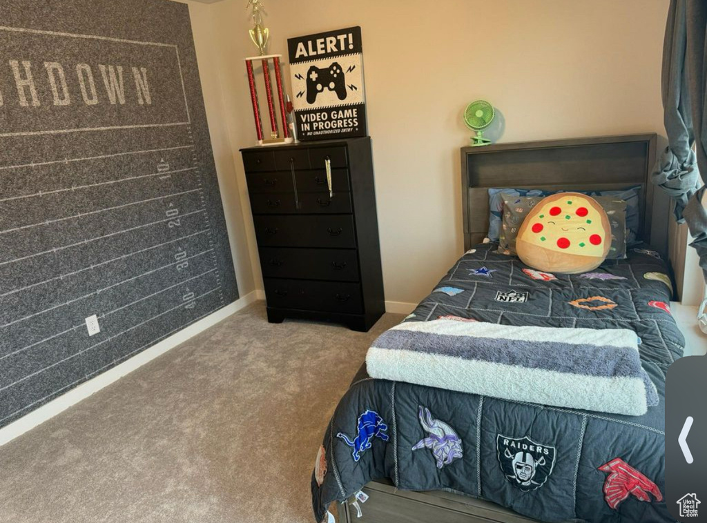 Carpeted bedroom featuring baseboards