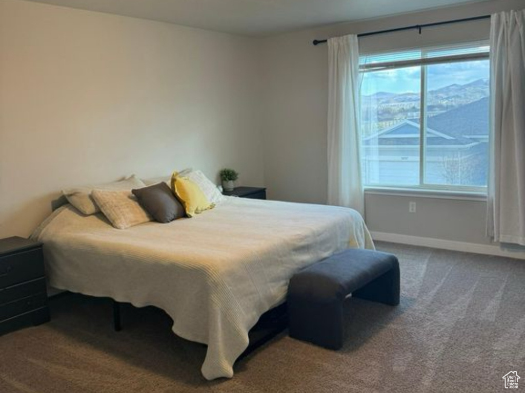 Bedroom featuring a textured ceiling, carpet flooring, and baseboards