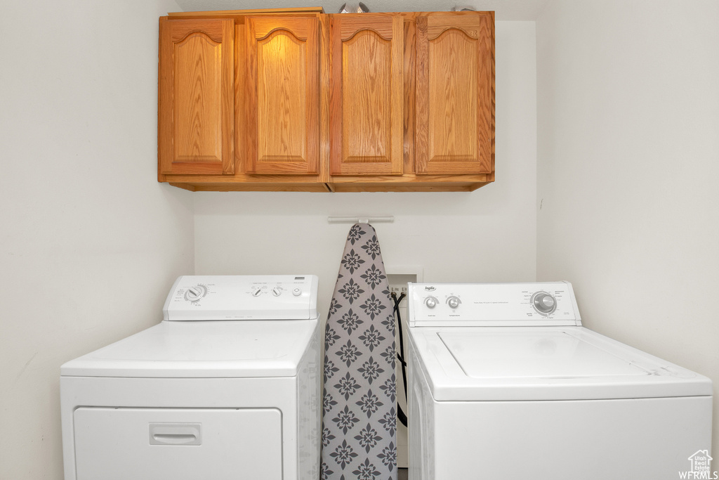 Laundry area with cabinet space and washer and dryer
