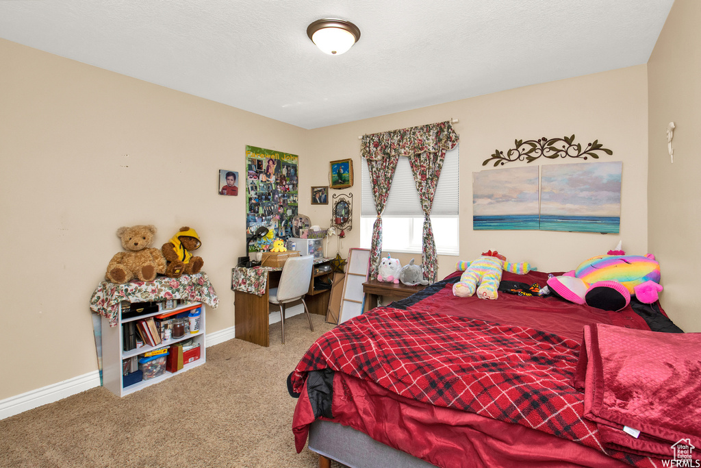 Carpeted bedroom featuring baseboards