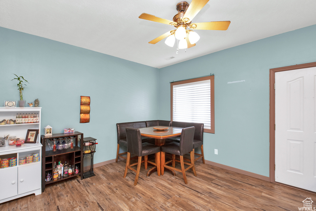 Dining area with wood finished floors, ceiling fan, and baseboards