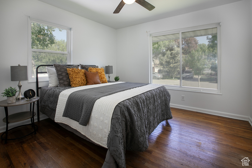 Bedroom with hardwood / wood-style floors, baseboards, and a ceiling fan