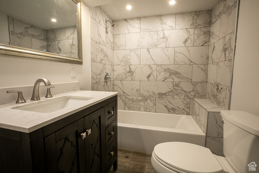 Full bath featuring toilet, shower / bath combination, recessed lighting, and vanity