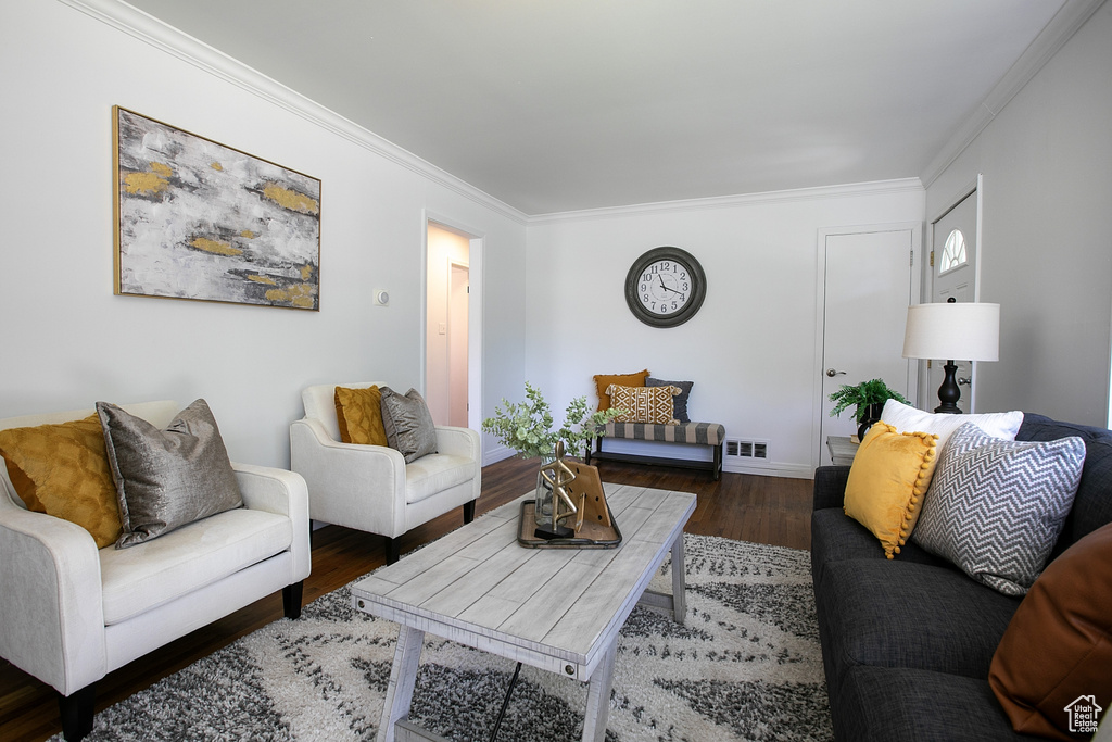 Living room featuring ornamental molding, wood finished floors, and baseboards