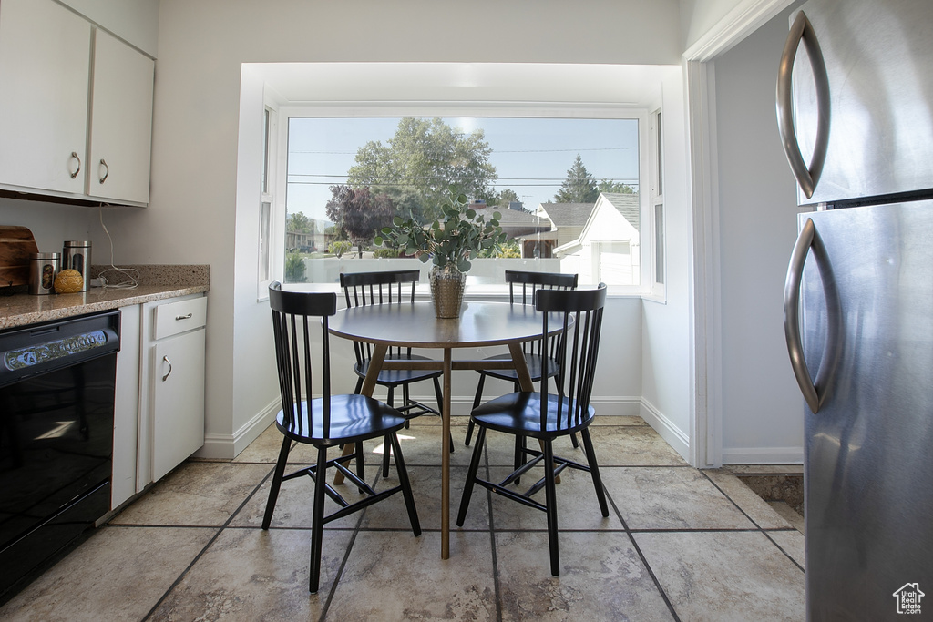Dining space featuring baseboards and bar area