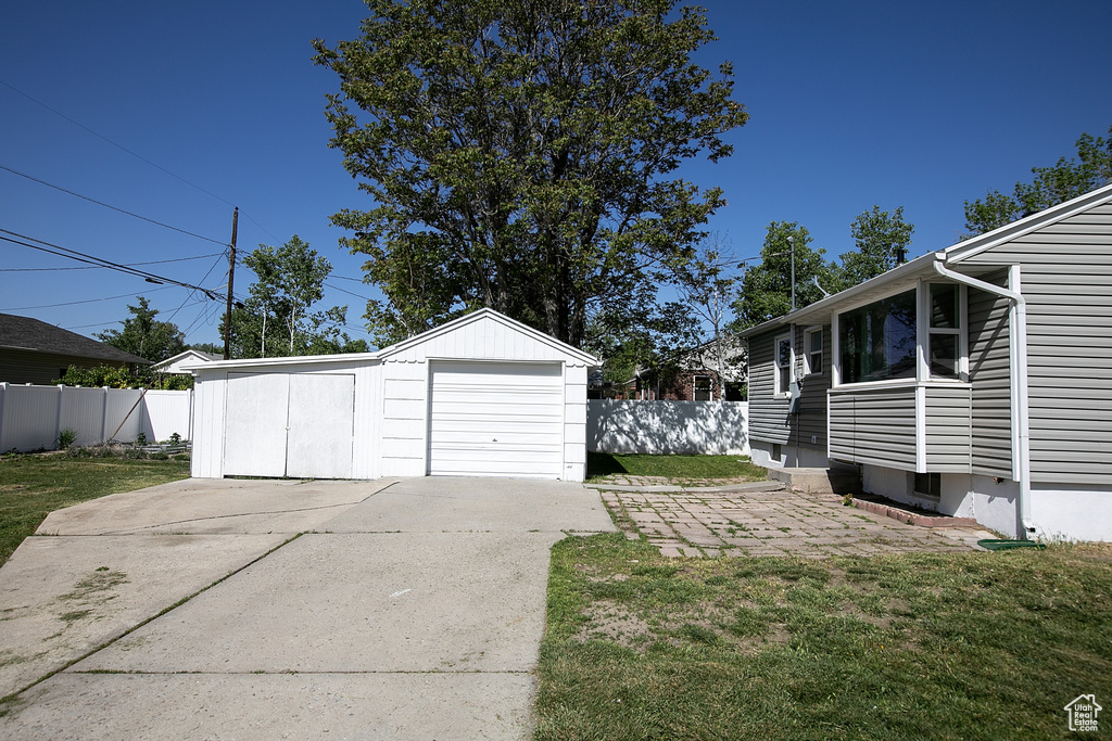 Detached garage with concrete driveway