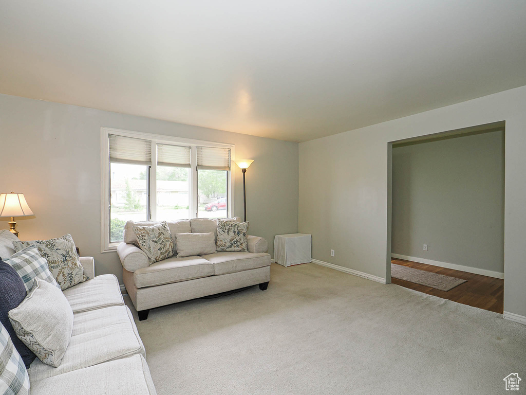 Carpeted living room featuring baseboards