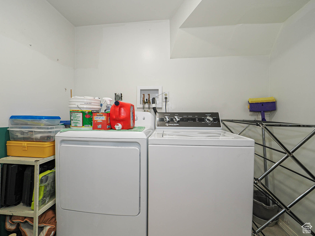 Clothes washing area featuring washer and clothes dryer