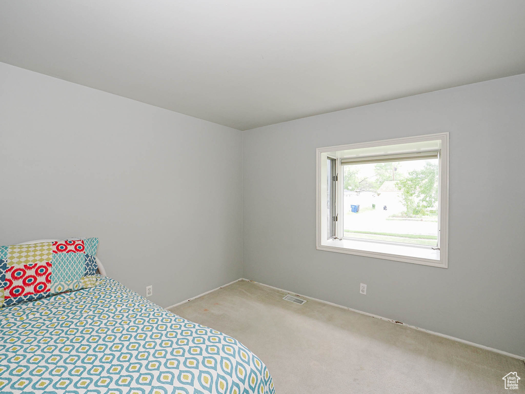 Bedroom featuring carpet flooring and baseboards