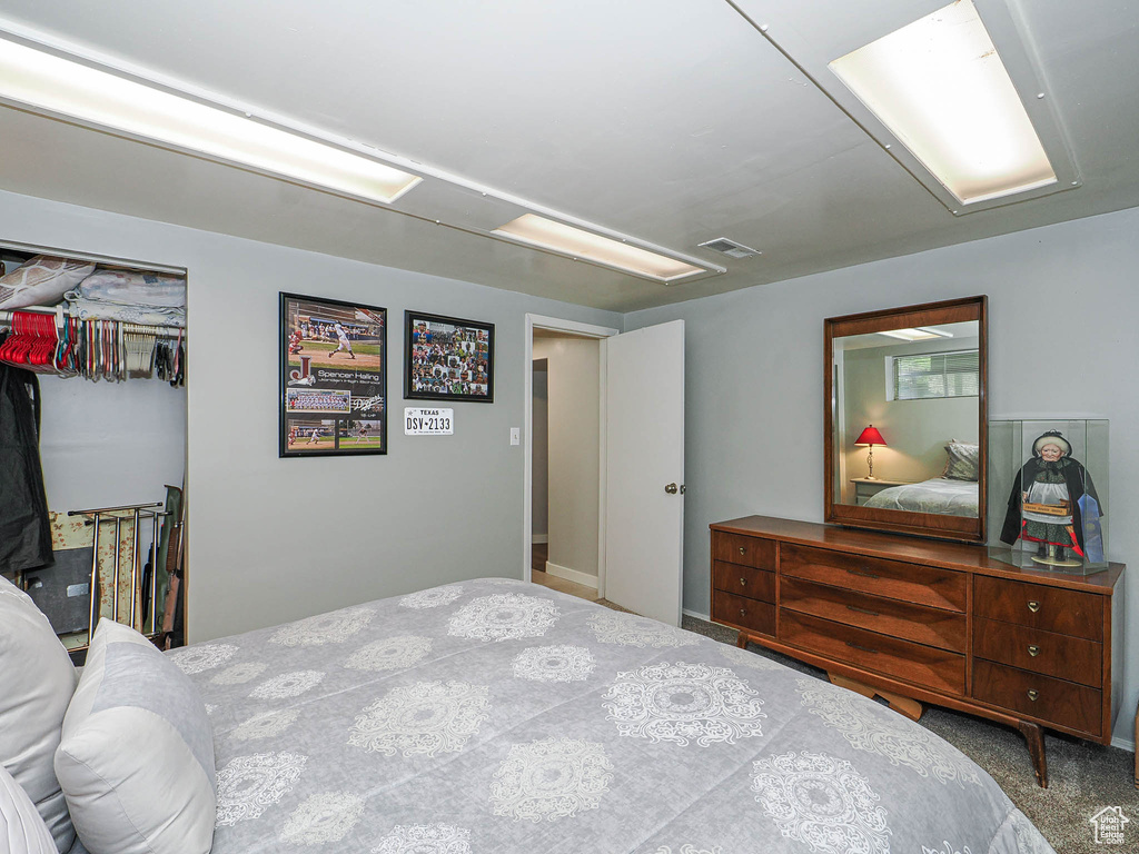 Bedroom with a closet, a spacious closet, and carpet floors