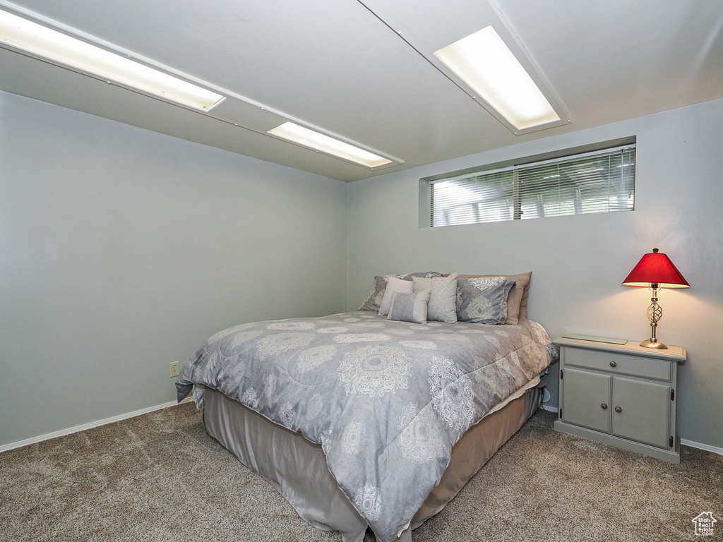 Bedroom featuring carpet floors and baseboards
