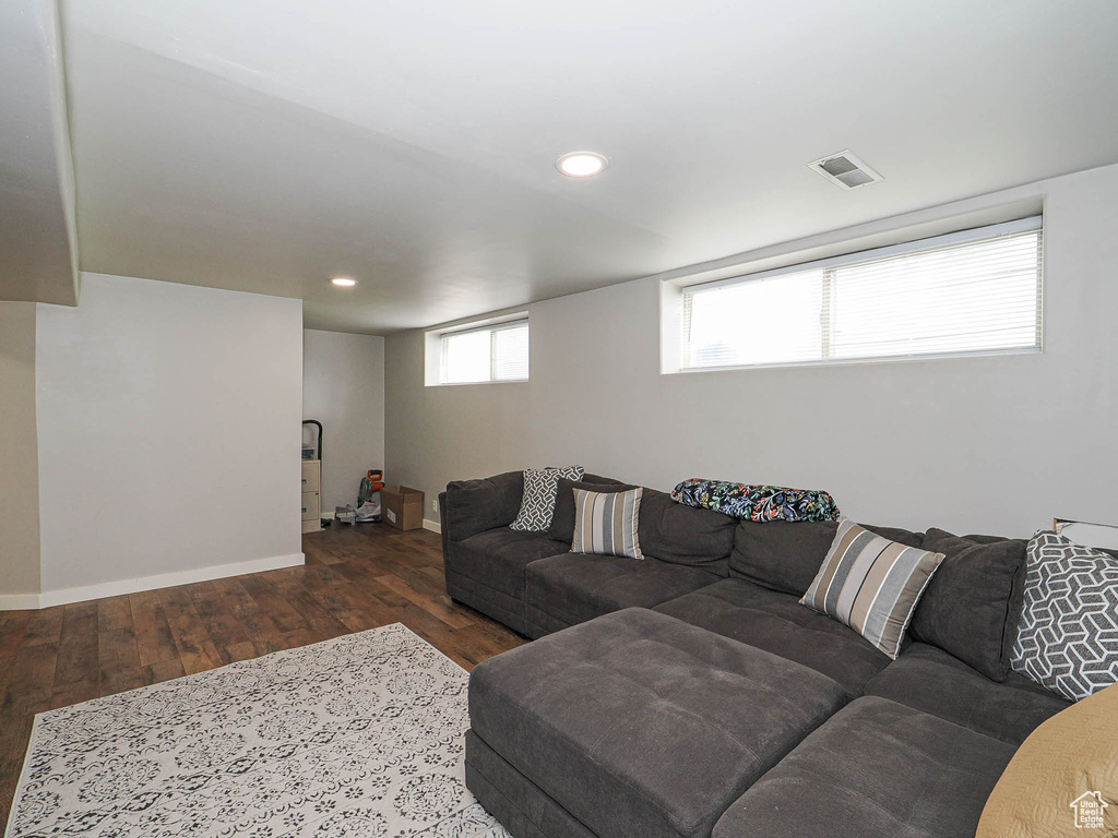 Living room with wood finished floors, baseboards, and recessed lighting