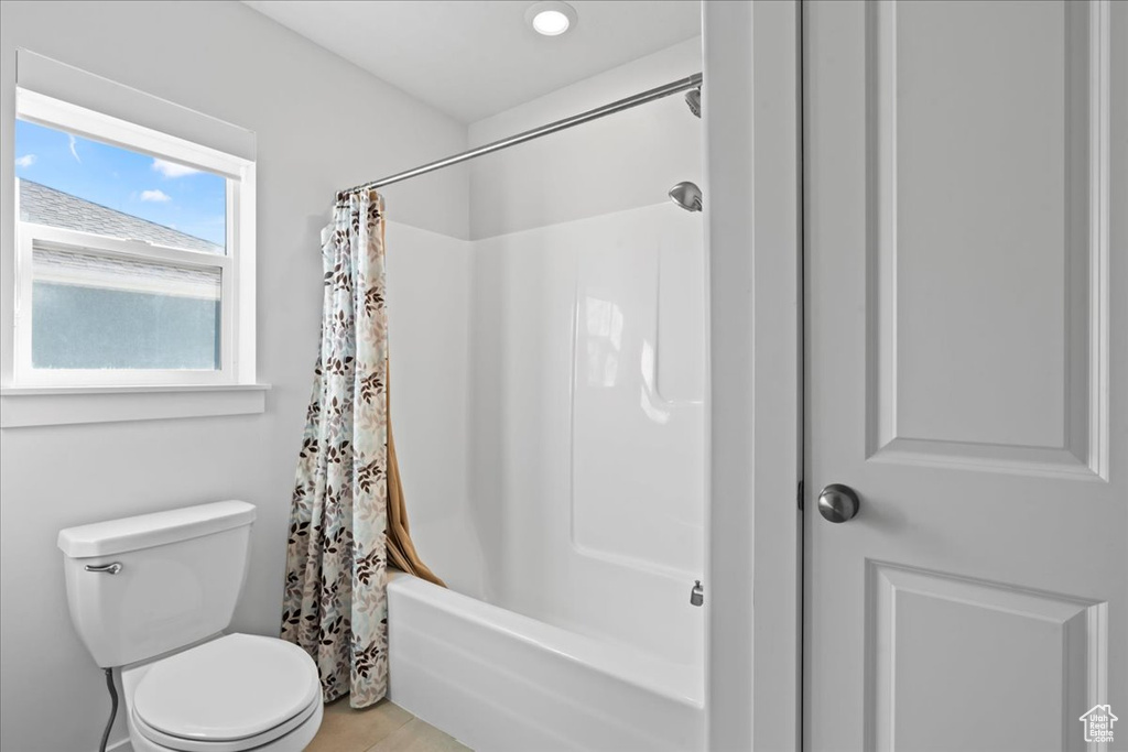 Bathroom featuring shower / bath combo and toilet