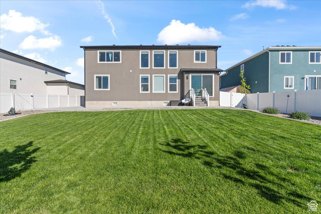 Rear view of house with stucco siding