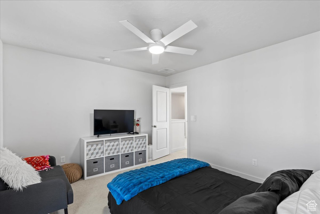 Carpeted bedroom featuring baseboards and ceiling fan