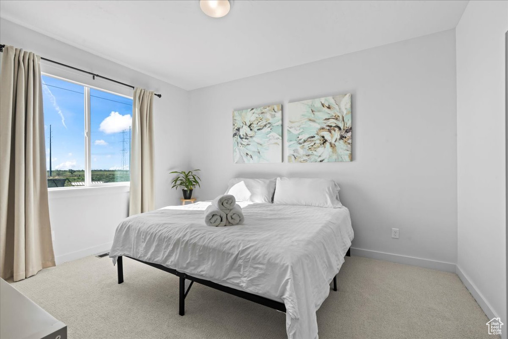 Carpeted bedroom featuring baseboards