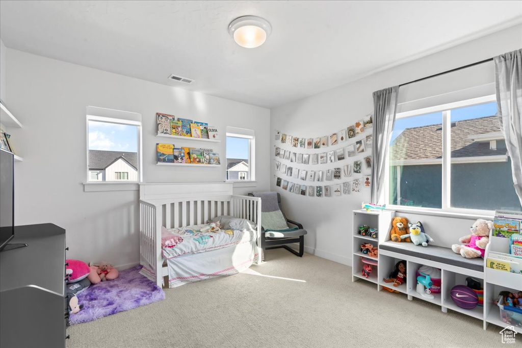 Carpeted bedroom featuring baseboards