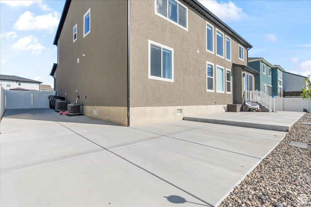 Back of property featuring fence, a patio, crawl space, and stucco siding
