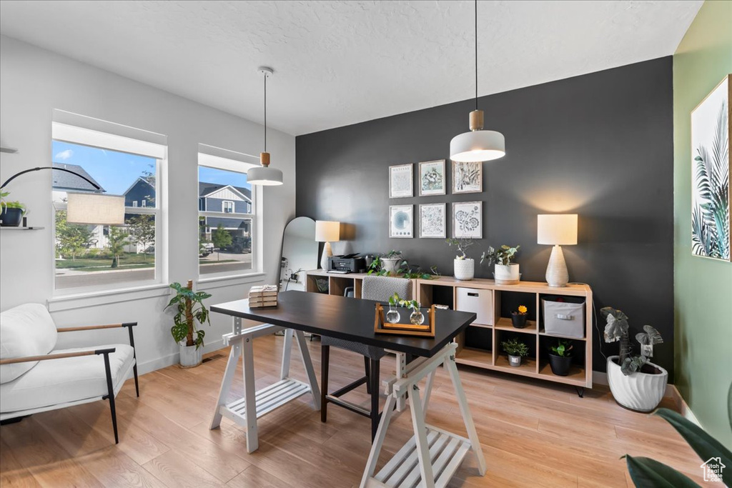 Home office featuring light wood finished floors and baseboards