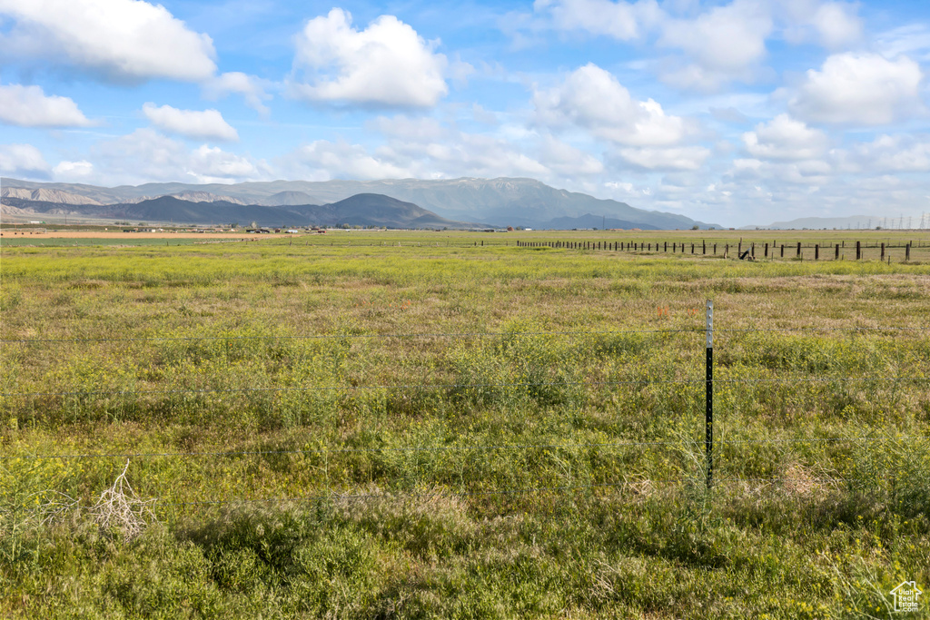 View of mountain backdrop with rural landscape and agricultural land