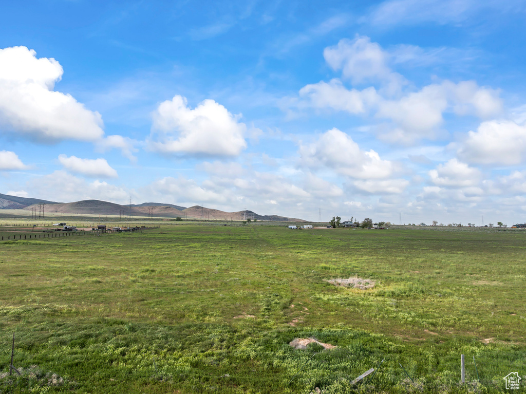 View of grassy yard featuring a view of rural / pastoral area and a mountain view