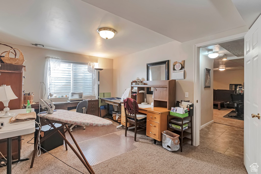 Office area featuring light colored carpet and light tile patterned floors