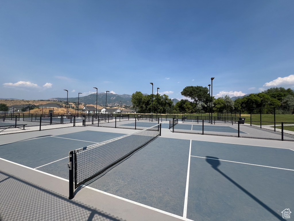 View of sport court with fence and a mountain view