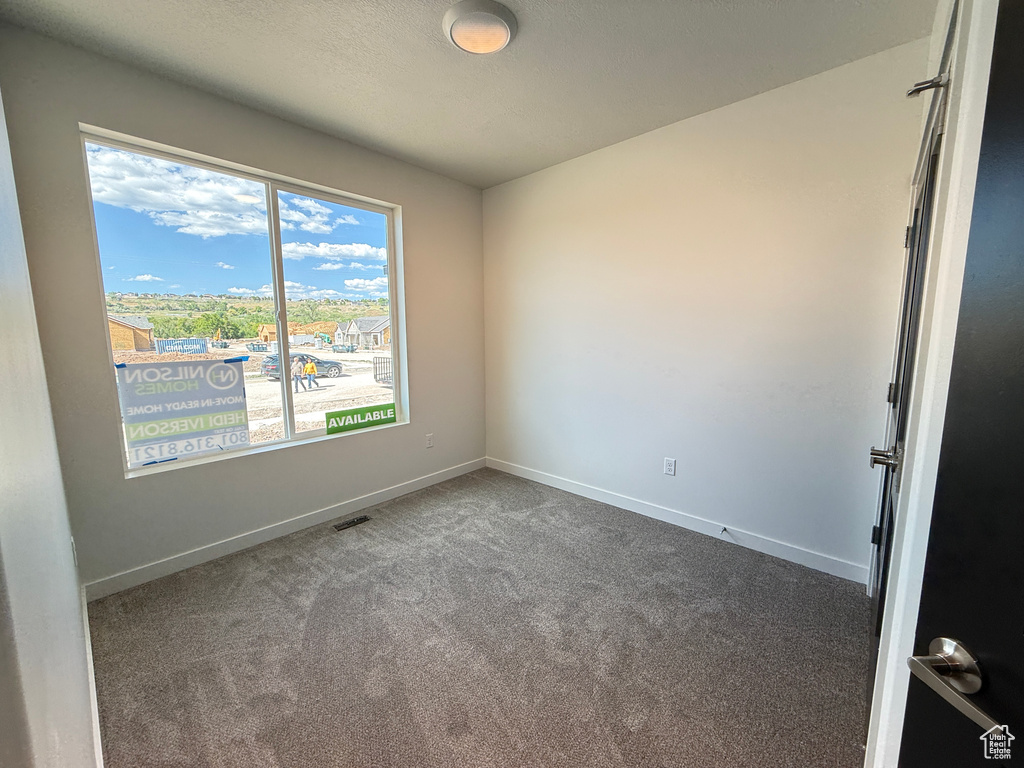 Spare room with carpet flooring and baseboards