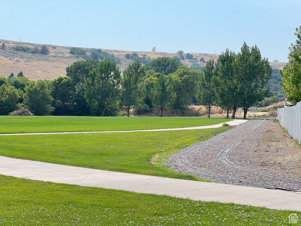 View of community featuring a yard and fence