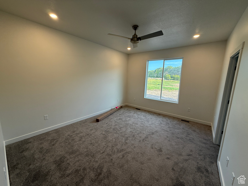 Carpeted empty room with a ceiling fan, recessed lighting, and baseboards
