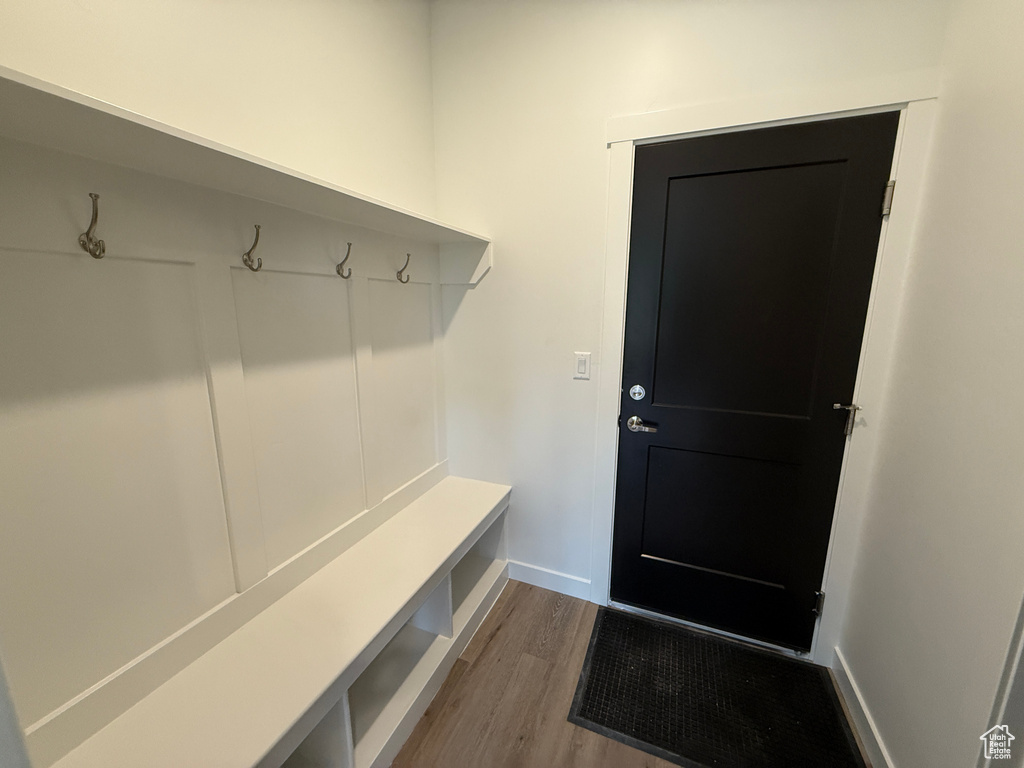 Mudroom with dark wood finished floors and baseboards