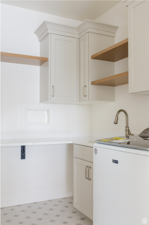 Kitchen featuring open shelves, refrigerator, light floors, and light countertops