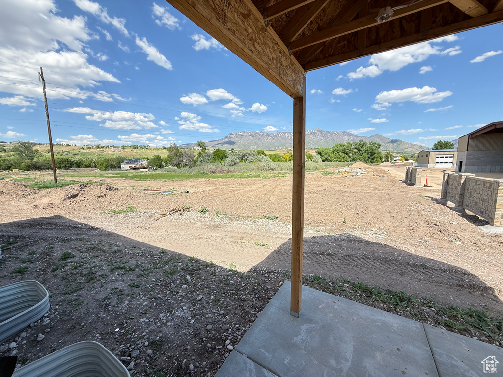 View of yard with a mountain view and a patio area