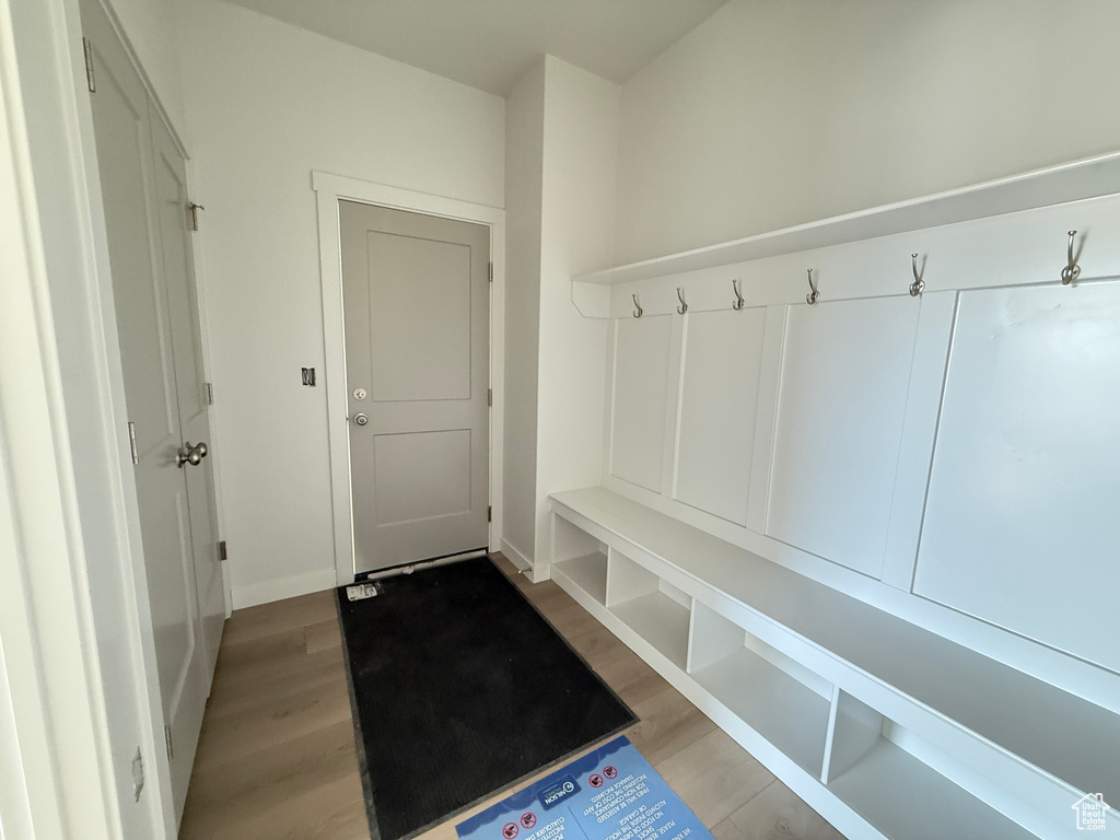Mudroom with light wood finished floors and baseboards