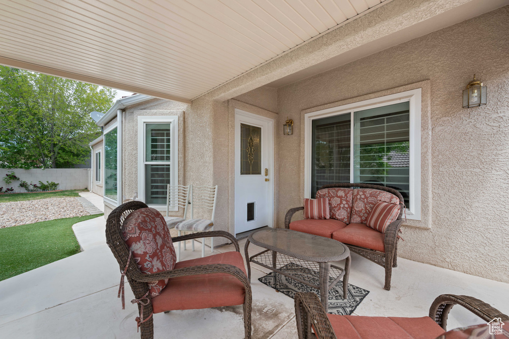 View of patio featuring fence