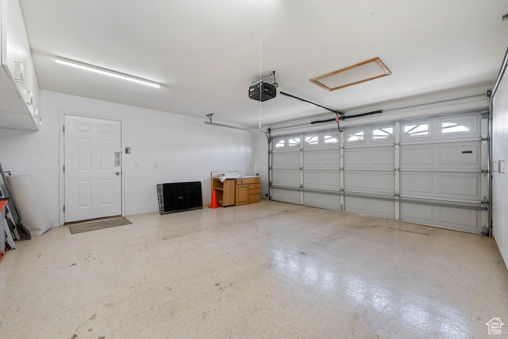 Garage featuring a garage door opener