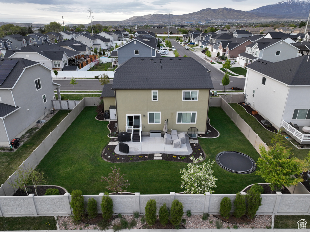 Aerial view of residential area featuring a mountainous background