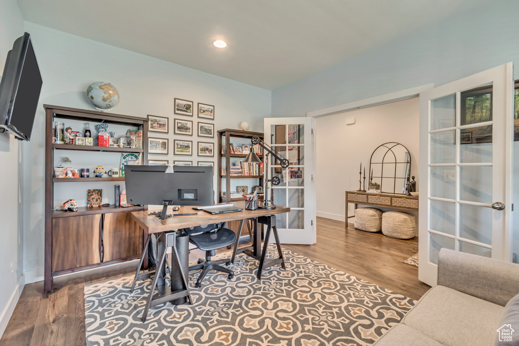 Office with wood finished floors, french doors, and baseboards