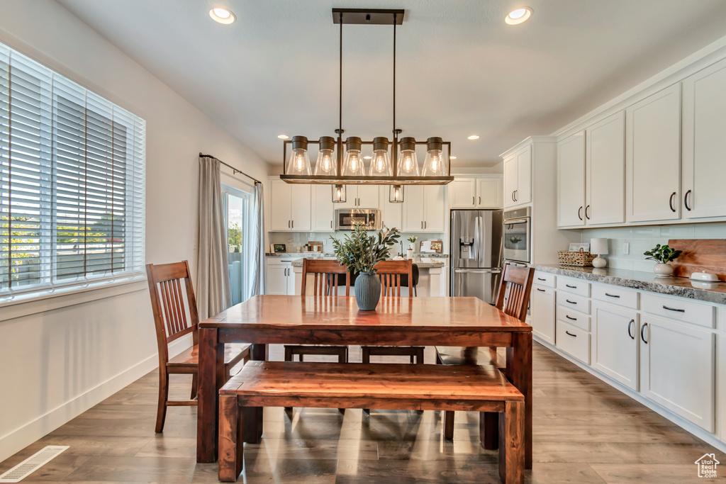 Dining space featuring recessed lighting, light wood-style flooring, and baseboards