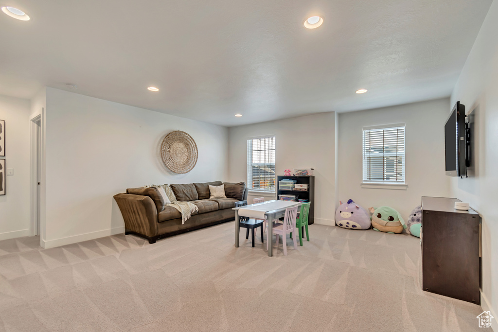 Living room featuring light carpet, recessed lighting, and baseboards