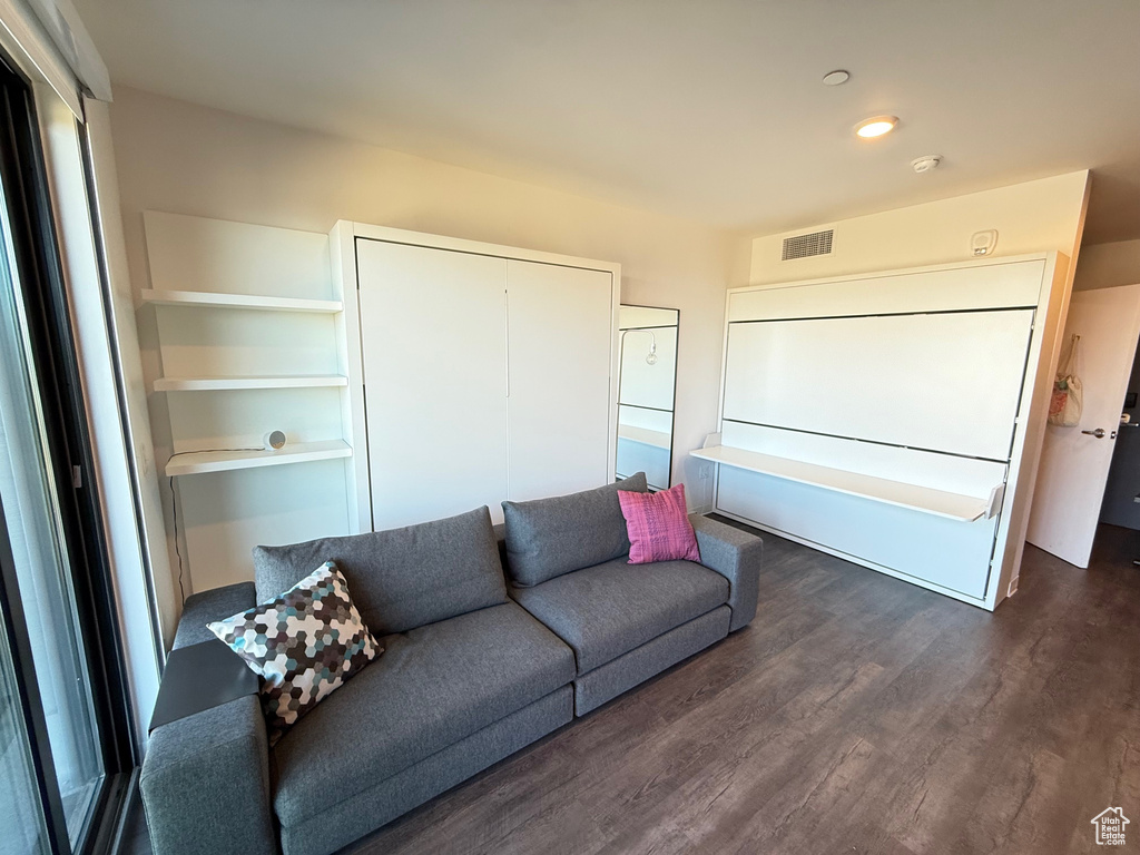 Living area featuring dark wood-style flooring