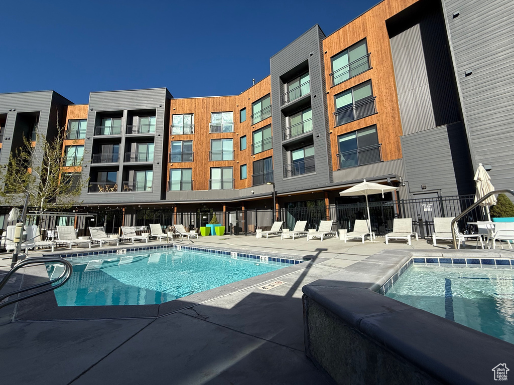 Community pool with fence and a patio area