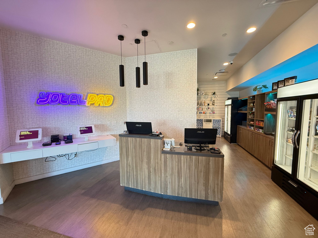 Home office with wood finished floors and recessed lighting
