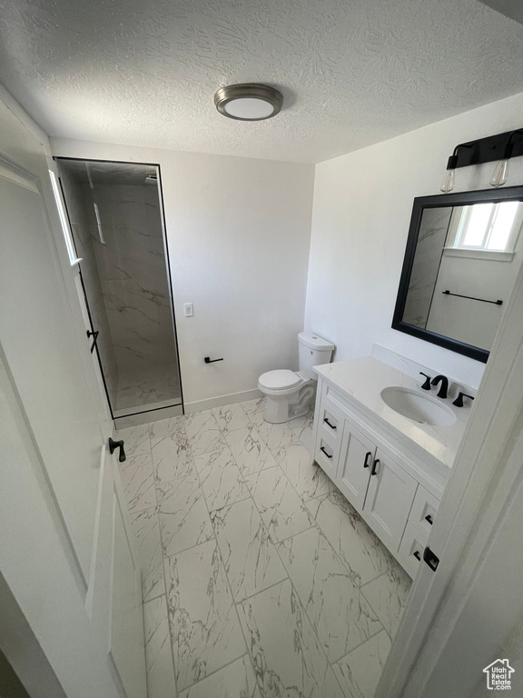 Full bathroom with marble finish flooring, a walk in shower, vanity, toilet, and baseboards