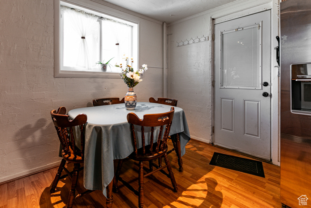 Dining room featuring wood finished floors and ornamental molding