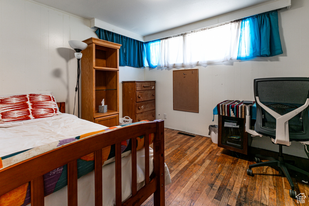 Bedroom featuring wood-type flooring