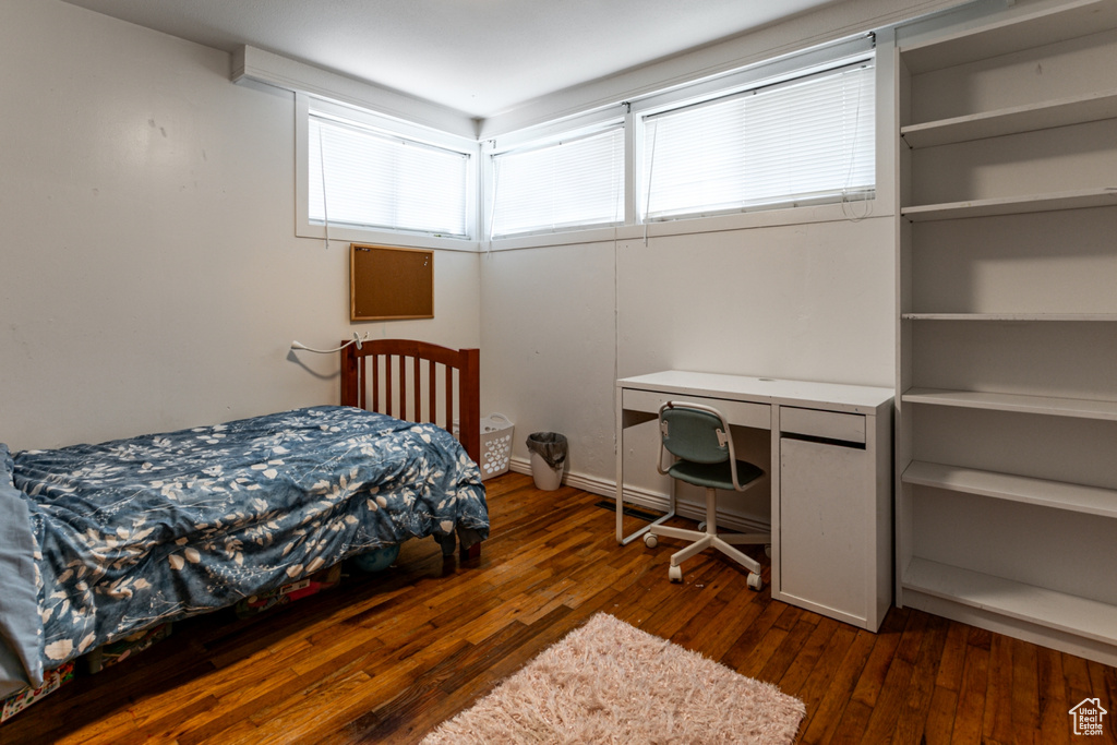 Bedroom with dark wood-style flooring